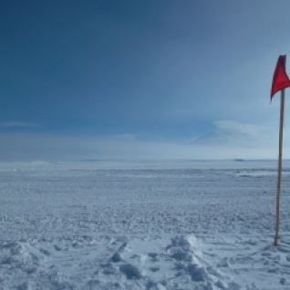 It was a very foggy day in the mountains. Here, a flag past which you can't go or else risk falling in a crevasse, and a very faint Mt. Erebus.